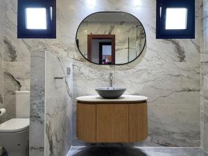 a bathroom with a sink and a mirror at Ecopausa Somió - Gijón in Gijón +27 photos
