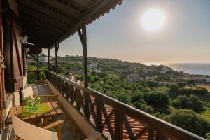 a balcony with chairs and a view of the ocean at Agnanti Seaview Villas in Karlovasi +29 photos
