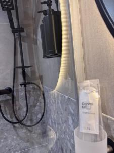 a bathroom with a shower with a mirror and a camera at Villa Johannes in Warmensteinach +22 photos