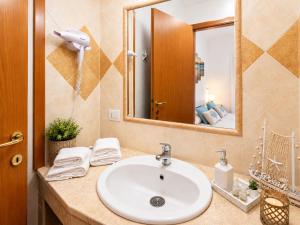 a bathroom with a sink and a mirror at Quiet Home in Pula