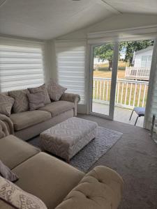 a living room with a couch and a table at Nancy staycation in Clacton-on-Sea