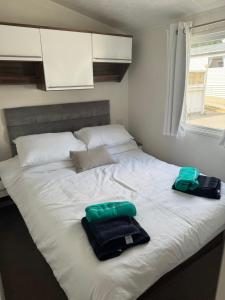 a large white bed with two bags on it at Nancy staycation in Clacton-on-Sea