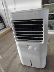 a white refrigerator freezer sitting on a kitchen floor at studio in Le Grau-du-Roi