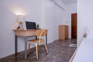 a desk with a laptop and a chair in a bedroom at The Pad CoLiving in Cebu City