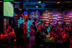 a crowd of people in a bar with neon lights at Sea Beach Hostel & Club Beachfront 18-39 years only in Ao Nang Beach +35 photos