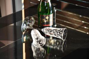 a bottle of wine and glasses on a table at Bella Casa 35 in Juliusruh