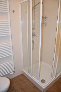 a shower with a glass door in a bathroom at Bella Casa 35 in Juliusruh +10 photos