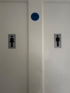 a bathroom with three signs on a wall at Strandhill Guesthouse in Sligo