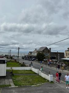 a group of people walking down a street at Strandhill Guesthouse in Sligo +23 photos