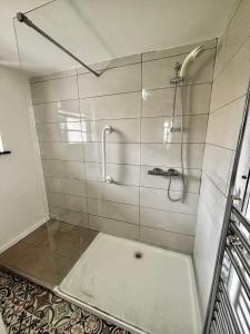 a bathroom with a shower with a glass door at Strandhill Guesthouse in Sligo