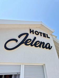 a hotel sign on the side of a building at Hotel Jelena in Brnaze