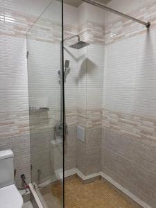 a shower with a glass door in a bathroom at Grand Turon Plaza Hotel in Tashkent