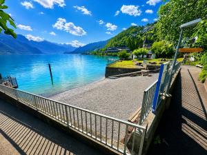 a bridge over a lake with mountains in the background at Lake House in Mühlehorn