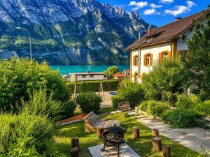 a house with a view of a lake and mountains at Lake House in Mühlehorn