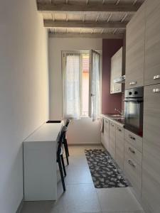 a kitchen with white cabinets and a counter top at Les Maisons Manzoni in Magenta