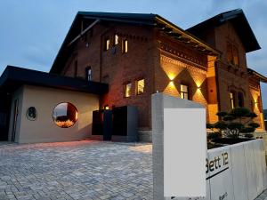 a large brick building with a round window on it at gleisbett12-4 in Meiningen