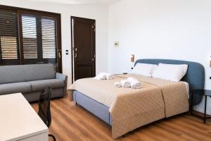 a bedroom with a bed and a couch at Sarah apartment in Taormina +19 photos