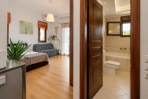 a living room with a toilet and a bathroom at Suite Acropolis Serres Parking EV Next to Center in Serres