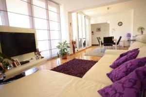 a living room with two beds and a flat screen tv at Base Bridge Apartment - Zadar City Centre - Free parking in Zadar