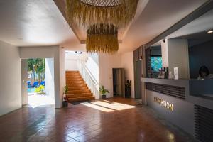 a hallway with a staircase and a chandelier at Serenity by Peace Garden, Koh Samui in Bangrak Beach