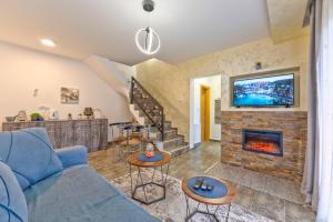 a living room with a blue couch and a fireplace at Brvnara Mont 3 in Zlatibor