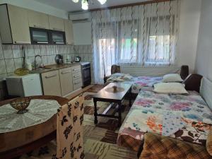 a kitchen with two beds and a table in a room at Roof - Holiday Home in Gjakove +8 photos