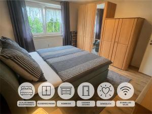 a bedroom with a bed with different symbols on it at Ferienwohnung Monika Ruhe & Natur nahe Bayreuth in Goldkronach