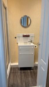 a bathroom with a white sink and a mirror at Rose Cottage Edinburgh in Edinburgh +45 photos