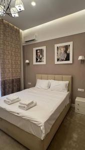 a bedroom with a large bed with two towels on it at Monro in Odesa +32 photos