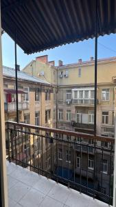 a balcony with a view of some buildings at Monro in Odesa