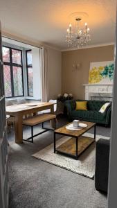 a living room with a couch and a table at Rose Cottage Edinburgh in Edinburgh