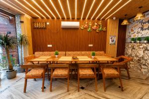 a dining room with a table and chairs at Hotel Ganga MBS Rishikesh # Best location # Family Hotel in Rishīkesh +7 photos