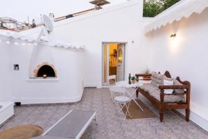 a living room with a couch and a fireplace at Emerald Courtyard House in Kranidi