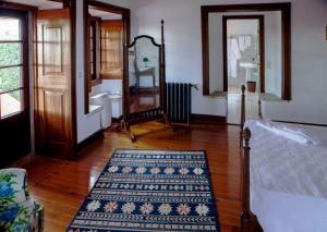 a room with a bed and a rug on a wooden floor at Quinta Santo António in Sintra