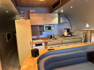 a kitchen with a wooden counter top in a room at Tin Can Town Oirschot in Oirschot