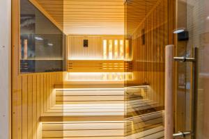a sauna with wooden floors and a glass wall at Brvnara Mont 3 in Zlatibor +13 photos