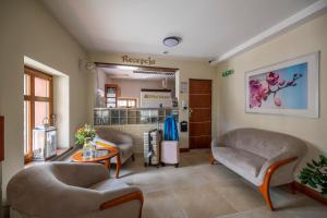a waiting room with couches and a table in a hospital at Apartamenty Pod Lwem in Świdnica