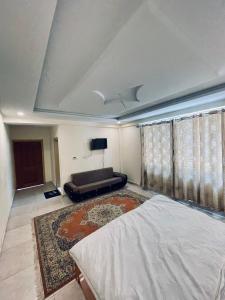 a bedroom with a bed and a couch at Lee Rivage Inn in Naran
