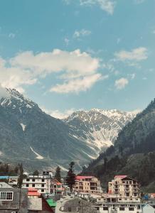 a view of a city with snow covered mountains at Lee Rivage Inn in Naran