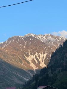 a mountain with snow on top of it at Lee Rivage Inn in Naran