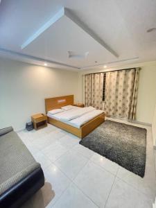 a bedroom with a bed and a couch at Lee Rivage Inn in Naran +11 photos