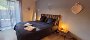 a bedroom with a bed with two towels on it at Clos De La Ronziere Avec Jacuzzi in Soulages