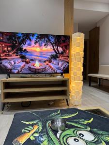 a large flat screen tv sitting on top of a table at Lost At Sea 2 in Sarandë