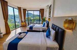 a hotel room with two beds and a large window at Serenity by Peace Garden, Koh Samui in Bangrak Beach