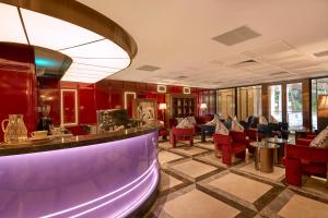 a bar in a restaurant with red chairs at Solaria d'Oriente Hotel in Hanoi