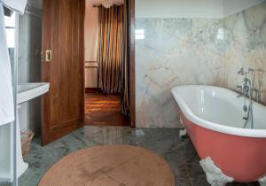 a bathroom with a bath tub and a claw foot tub at Quinta Santo António in Sintra +25 photos