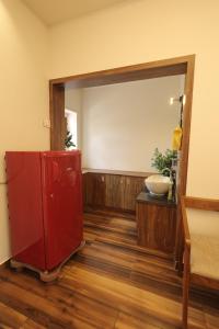 a bathroom with a red cabinet and a mirror at WinterHome homestay in Munnar