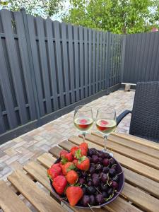 two glasses of wine and strawberries on a table at AMONG Nature Stay in Vilnius in Vilnius +9 photos