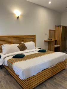 a large bed with pillows on it in a room at Sky view Resort Shogran in Shongran