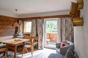 a living room with a table and a window at Untersillerhof in Neustift im Stubaital